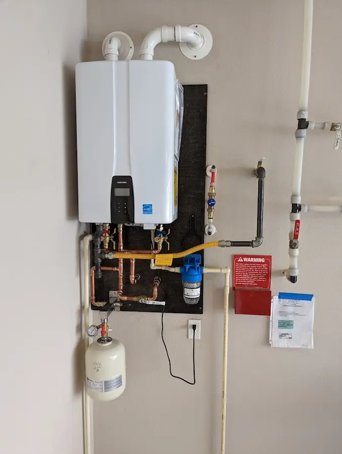 Professional plumber installing copper piping in a Avon home